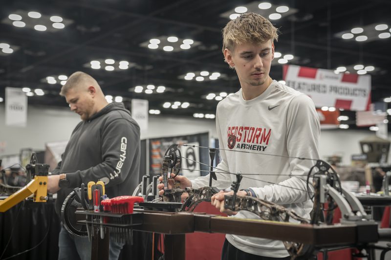 Compound bow cams and limbs being tuned on a bow press