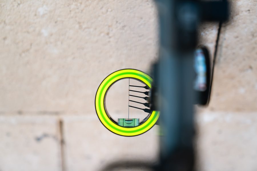 Compound bow sight pins through the housing during sighting in