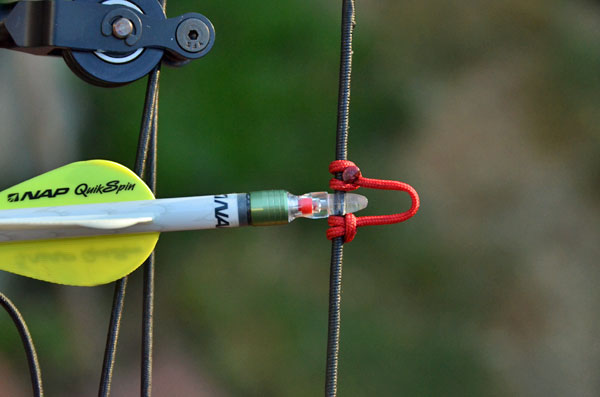 Nockturnal lighted arrow nock on bow string