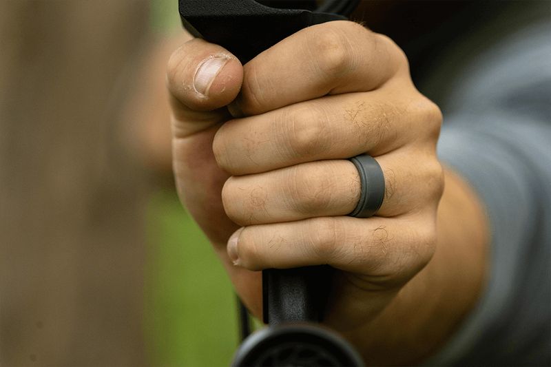 Death grip on a compound bow showing fingers wrapped too tight around the riser