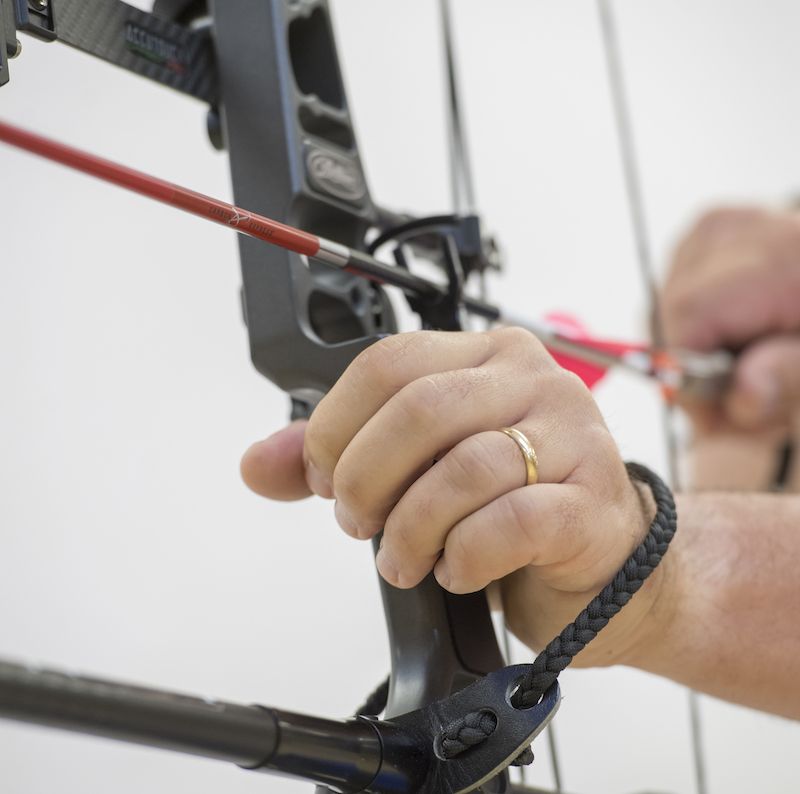 Drop away arrow rest types in motion at full draw