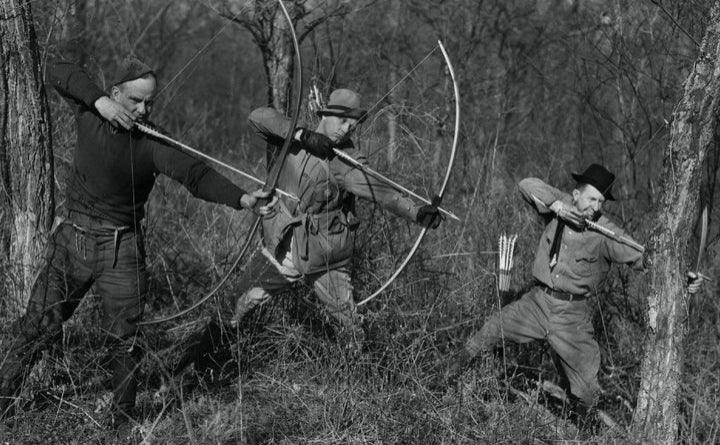 Instinctive archery hunters shooting traditional bows without sights