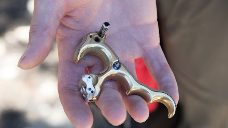 Hinge release archery back tension handheld close up gold body