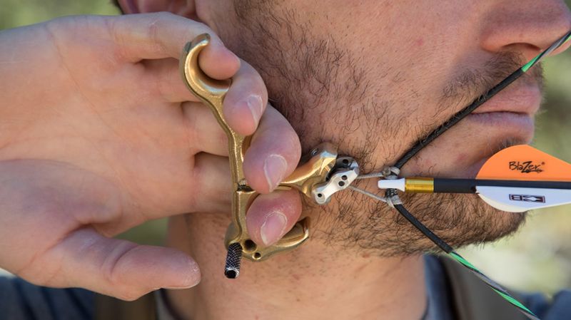 Hinge release archery hunting at anchor full draw against jaw