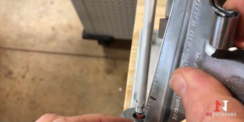 Close up of fletching jig clamping a vane against the shaft