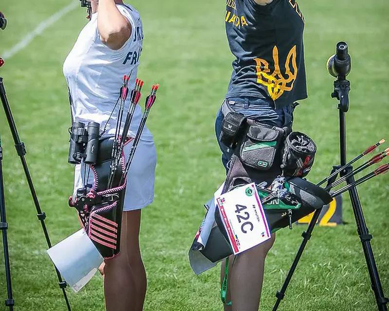 recurve archers wearing Olympic hip quivers on the shooting line