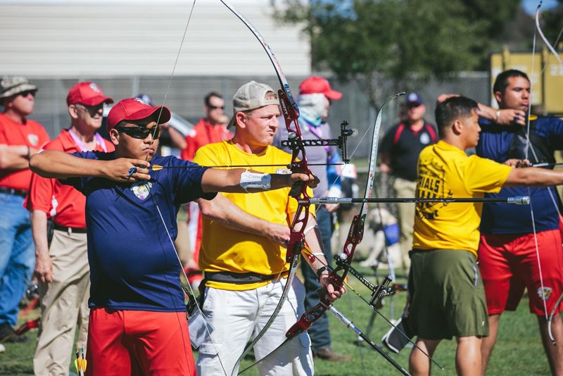 Archers shooting strung recurve bows at an outdoor range