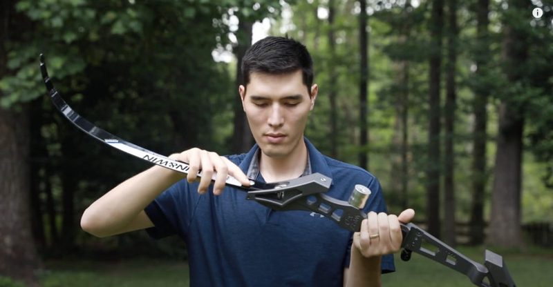 Recurve bow and bow stringer tool ready to string a recurve bow