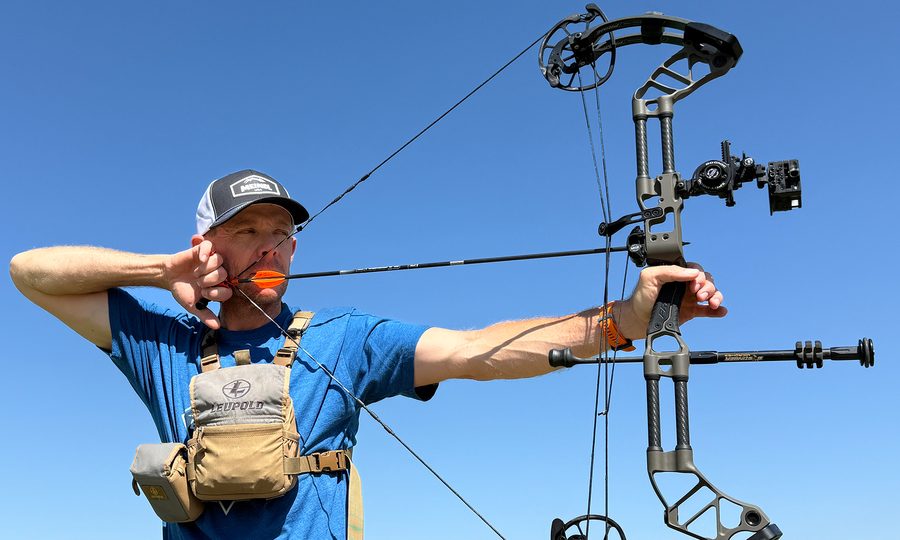 Sighting in a compound bow at full draw against a clear sky