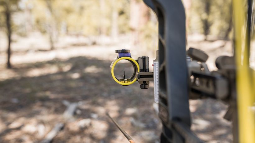 Single pin bow sight close up on a hunting compound bow in Western terrain