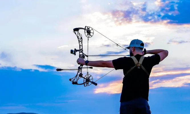 Bowhunter at full draw at sunset fighting target panic