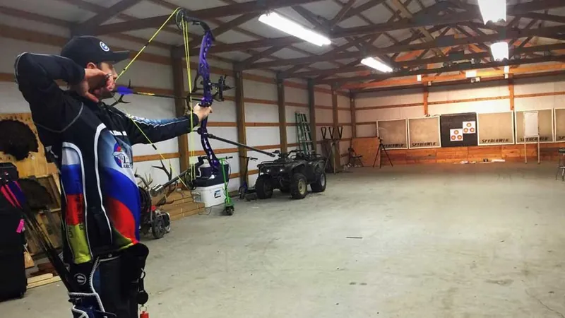 Archer practicing on indoor range to overcome target panic