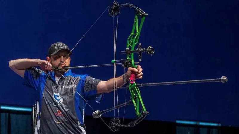 Pro compound archer aiming on stage avoiding target panic punch