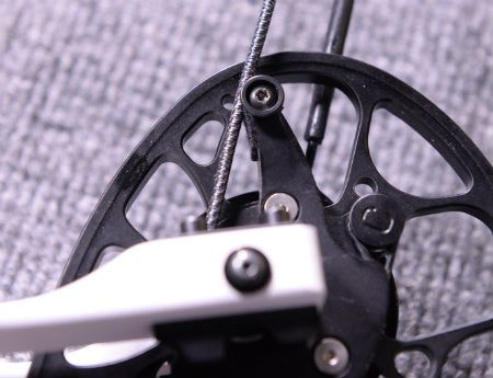 Two-cam compound bow showing the cam and module that requires synchronization for proper cam timing