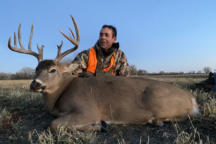 Bowhunter with a mature whitetail buck taken using a grunt call