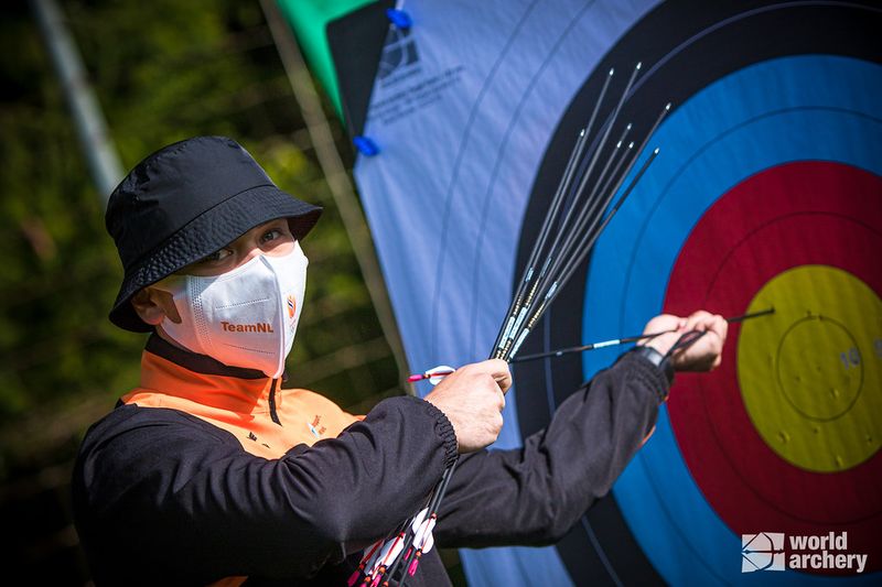 archer pulling arrows from bullseye target after practice drill