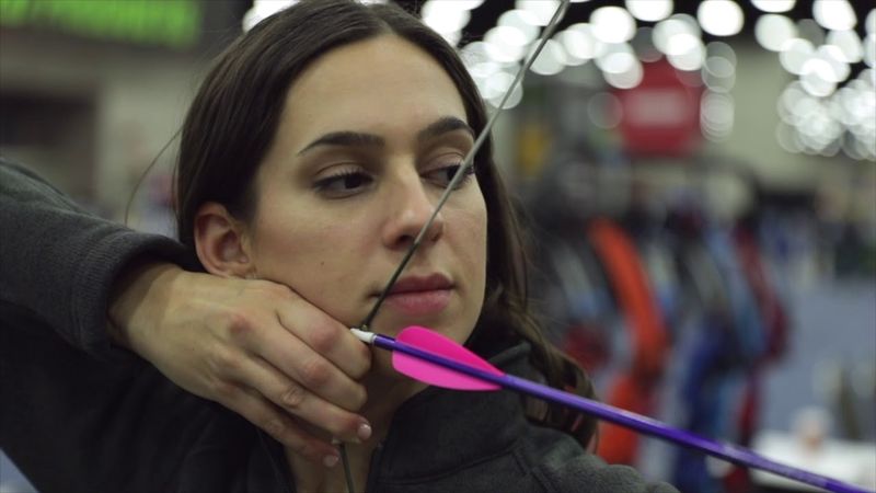 Archer at full draw with the drawing hand anchored at the jaw and corner of the mouth