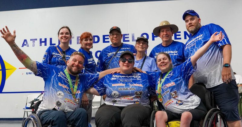 Archery club members and community gathered at a range