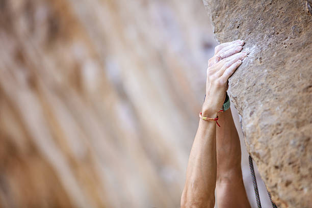 Closeup of climber's hands Closeup view of climber's hands on ledge of cliff climbing hand closeup grip during rock climbing 