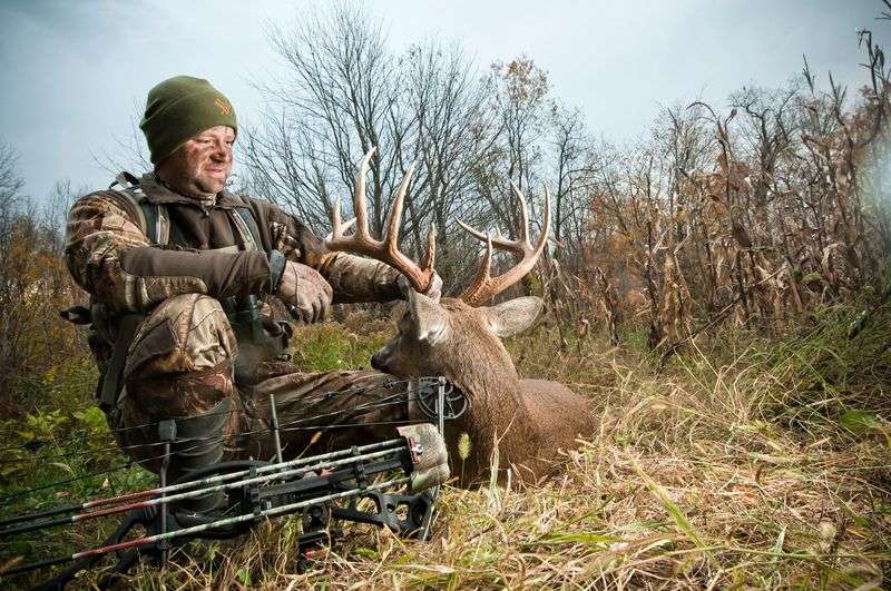 Successful bowhunter on public land with harvested deer