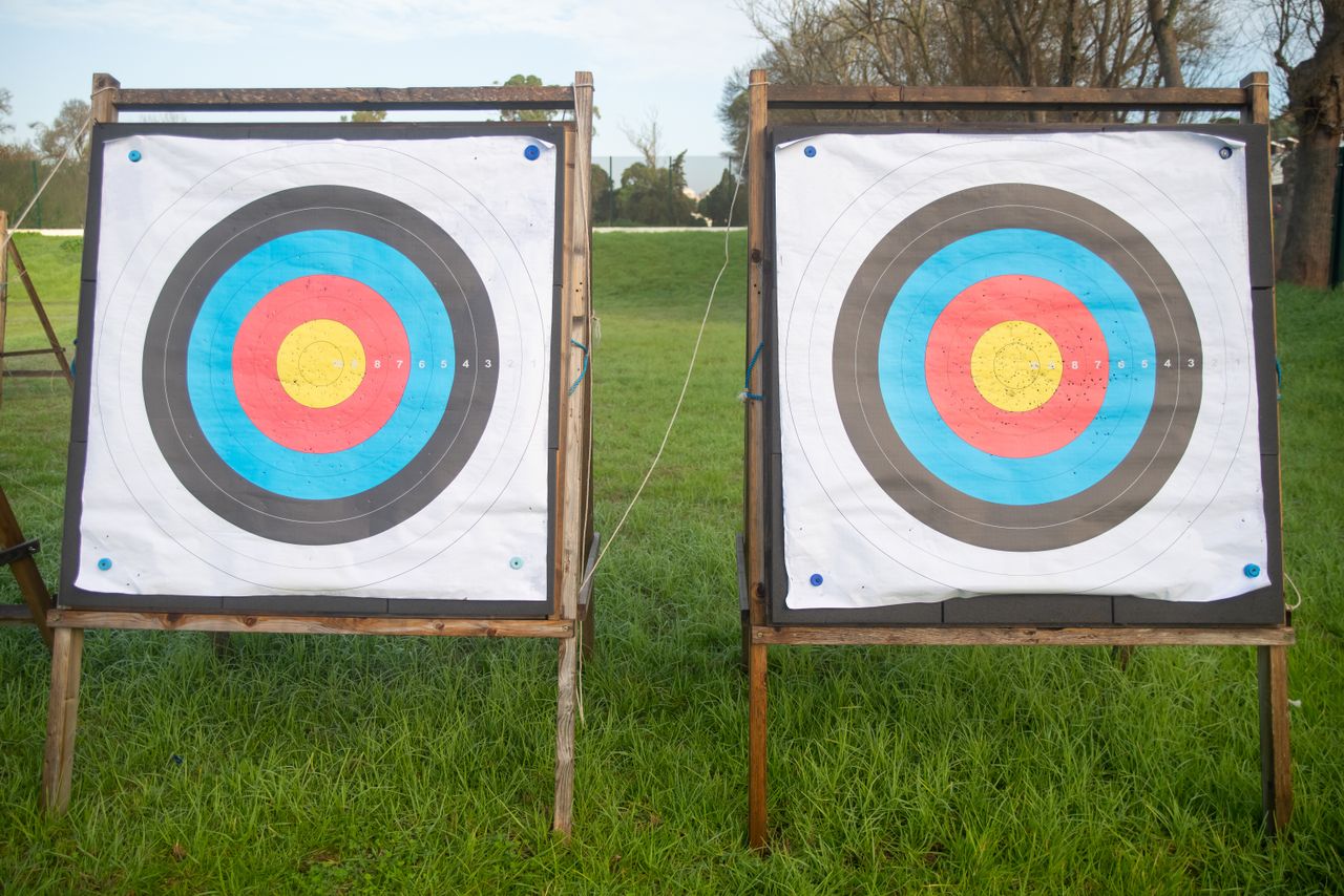Outdoor archery range with Olympic targets on grass field