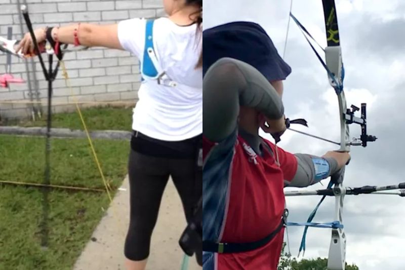 Archers practicing recurve archery at an outdoor range with a backstop