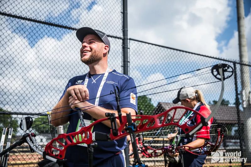 Compound archers waiting behind the safety line at a range