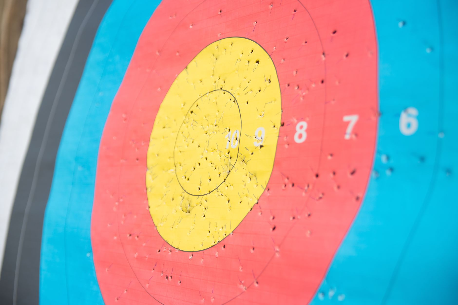 Olympic archery target face showing precision arrow grouping