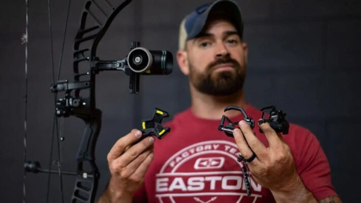 Archer comparing arrow rest types for compound bow — drop-away vs containment