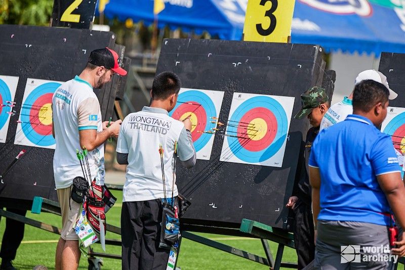 Arrows grouped in the gold center of a target face on the shooting range
