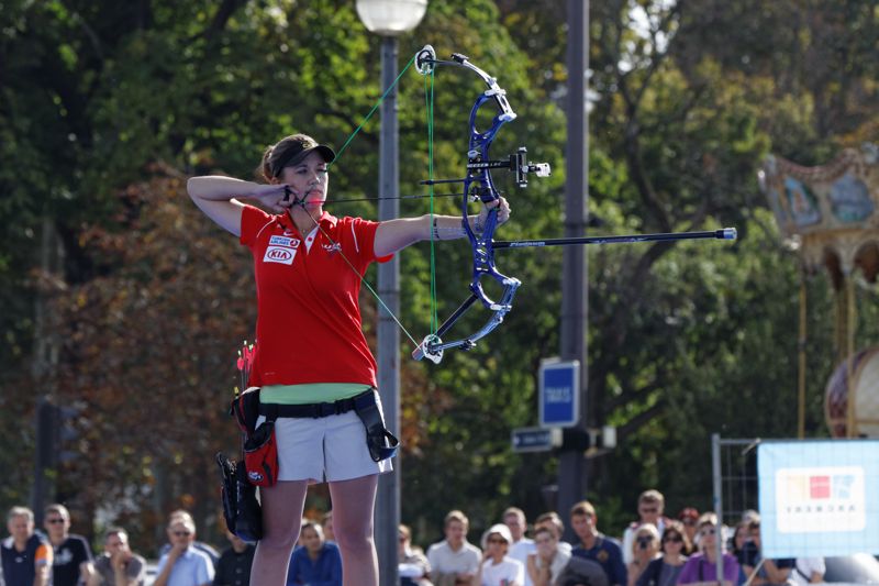 Compound bow archer aiming at the target