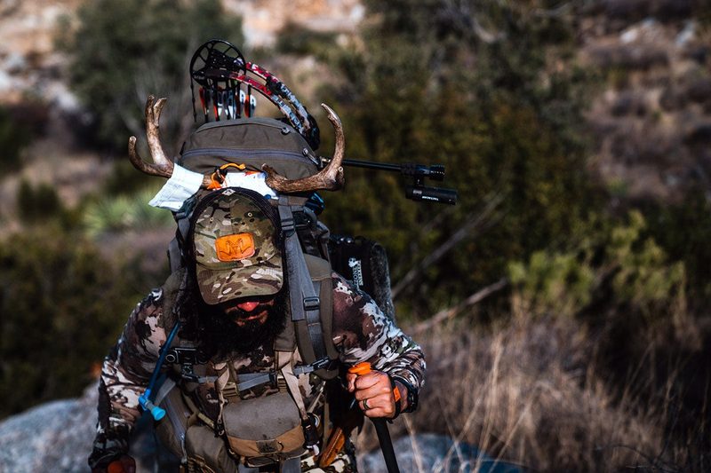 Bowhunter packing out after a successful hunt with a heavy hunting arrow setup
