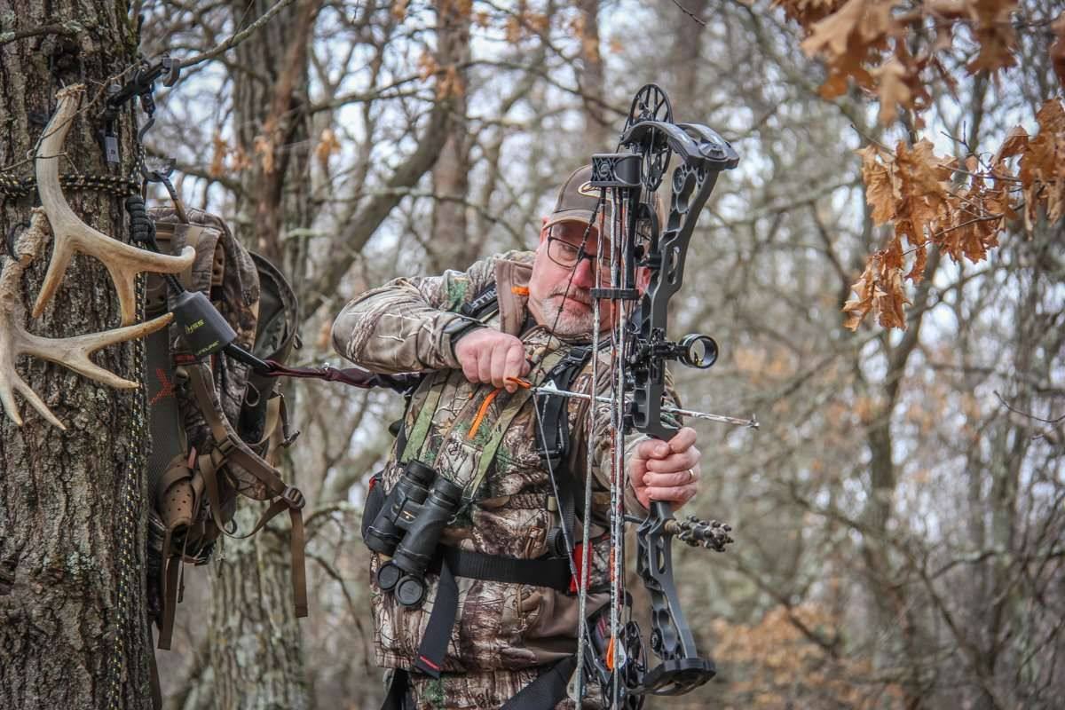 Bowhunter in the field on public land with compound bow