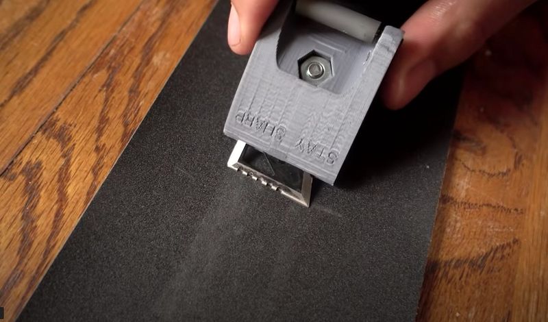 Broadhead sharpening jig used with sandpaper to hold a consistent angle