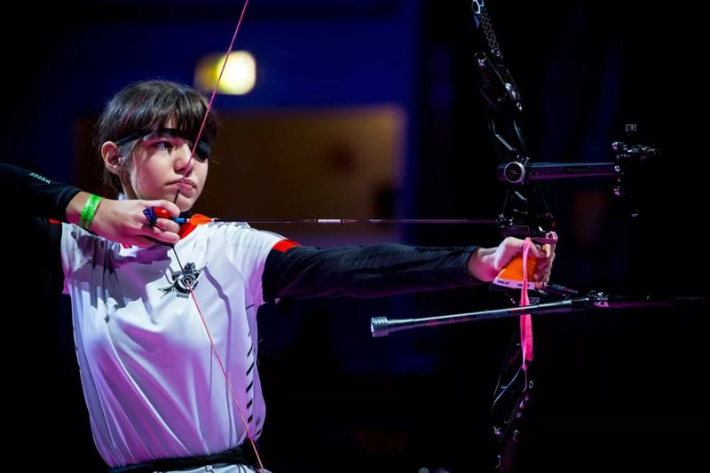 Compound archer at full draw aiming during a target competition