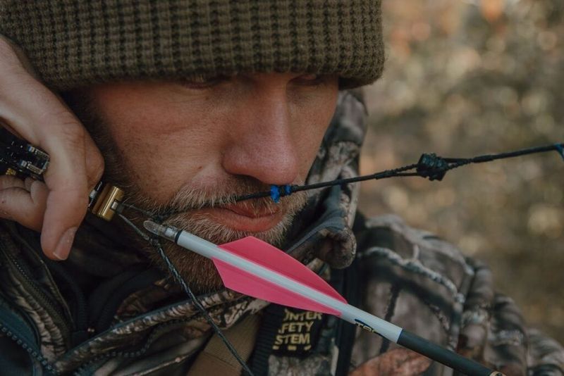Compound bow anchor point with the release hand set against the jaw