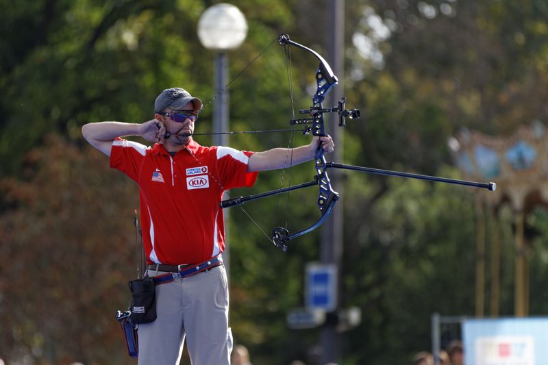 Archer at full draw with a compound bow in competition