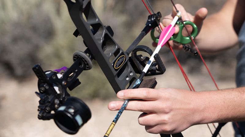 Nocked arrow on a compound bow rest during tuning for straighter arrow flight
