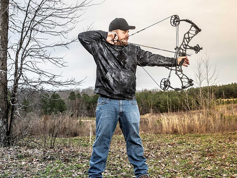 Archer demonstrating proper compound bow shooting stance and full draw form