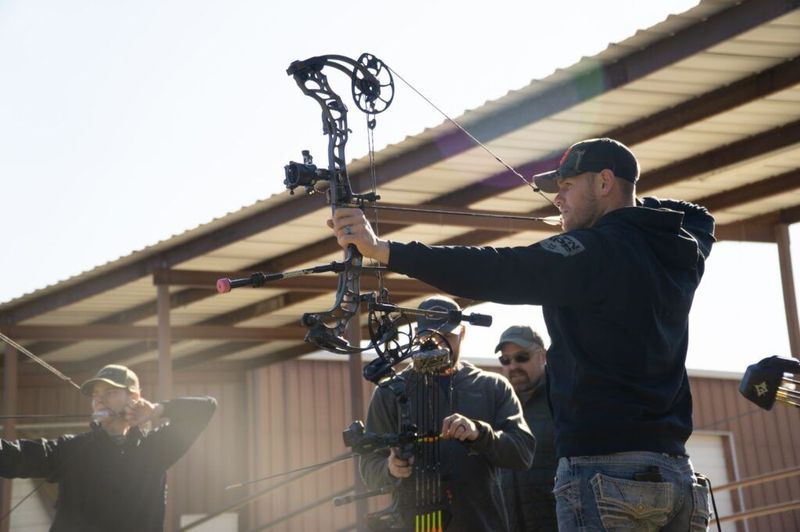Archer practicing how to shoot a compound bow on an outdoor range