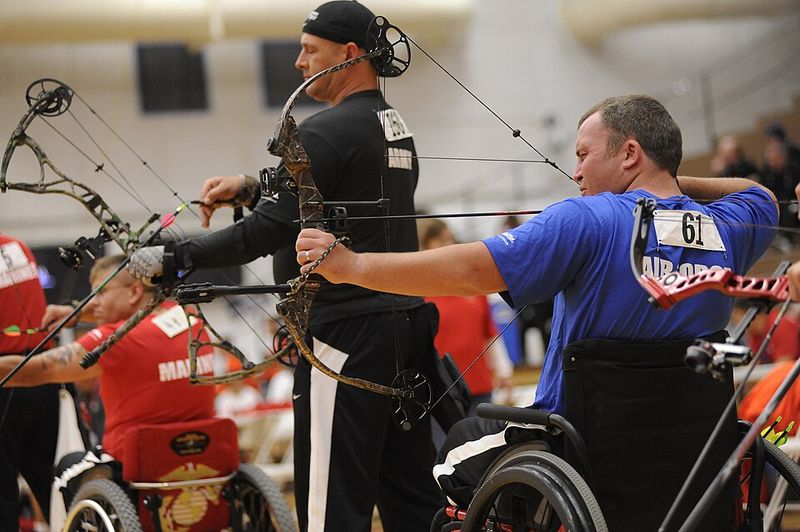 archers drawing compound bows demonstrating let-off and draw weight difference from recurve