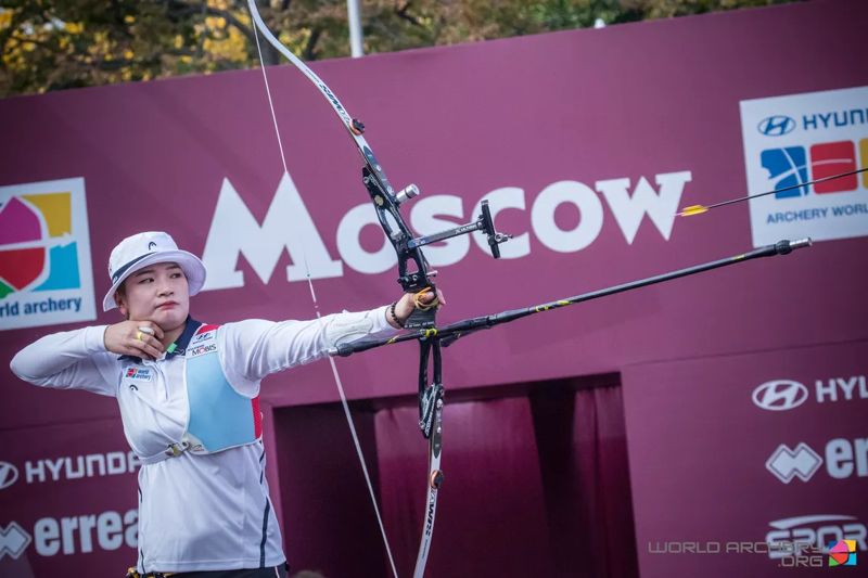 Recurve archer at full draw and anchor with sight and stabilizer at a World Archery event