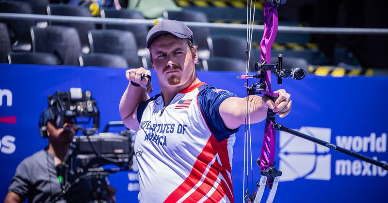 Archer competing at an indoor archery range
