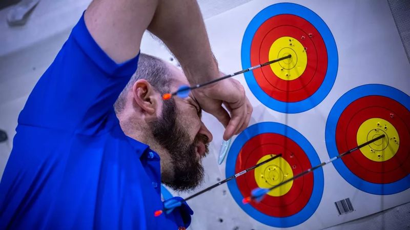 Arrows grouped in indoor archery target faces at a championship