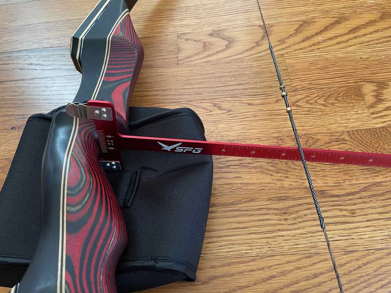 Measuring recurve bow brace height with a bow square