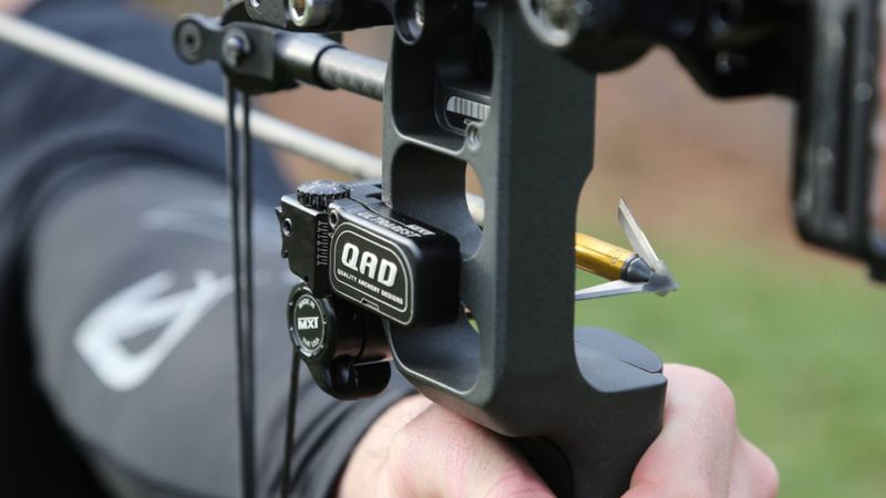 QAD drop away arrow rest on compound bow with broadhead-tipped hunting arrow nocked