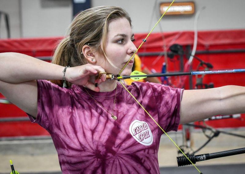 Recurve archer anchoring the string to the same facial reference points for consistent form