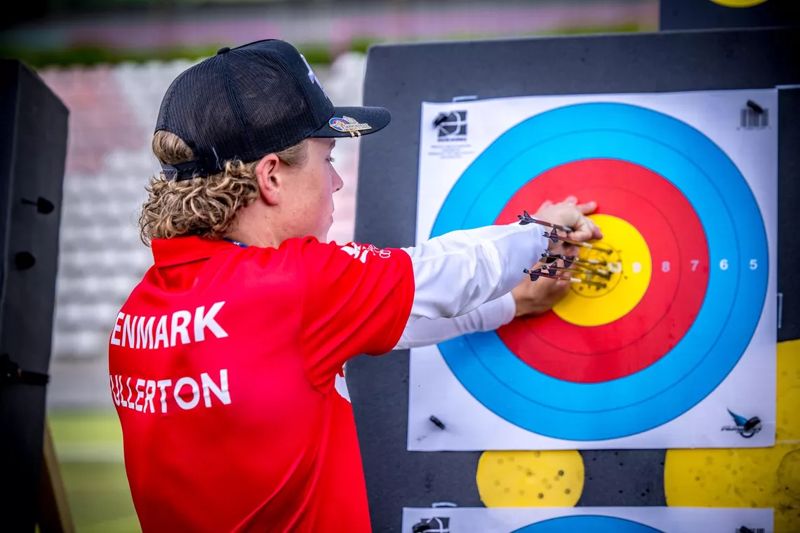 Tight recurve arrow grouping clustered in the target gold