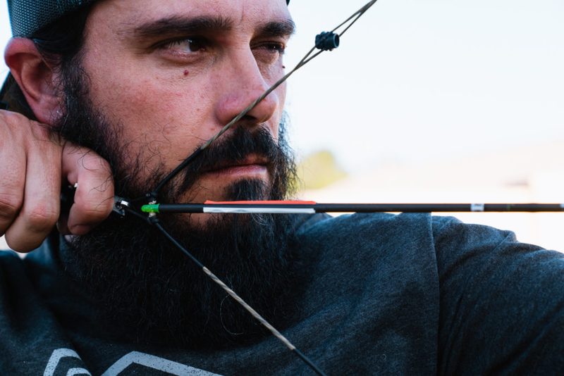 Archer at full draw shooting a bare shaft during bare shaft tuning