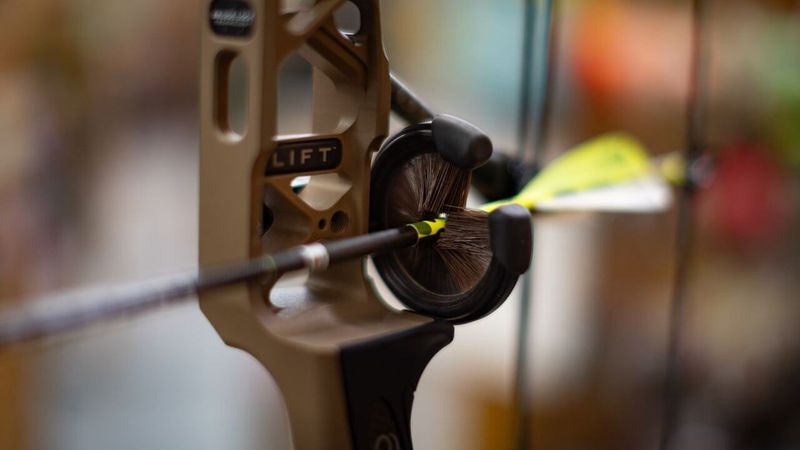 whisker biscuit full containment arrow rest with arrow loaded on compound bow riser